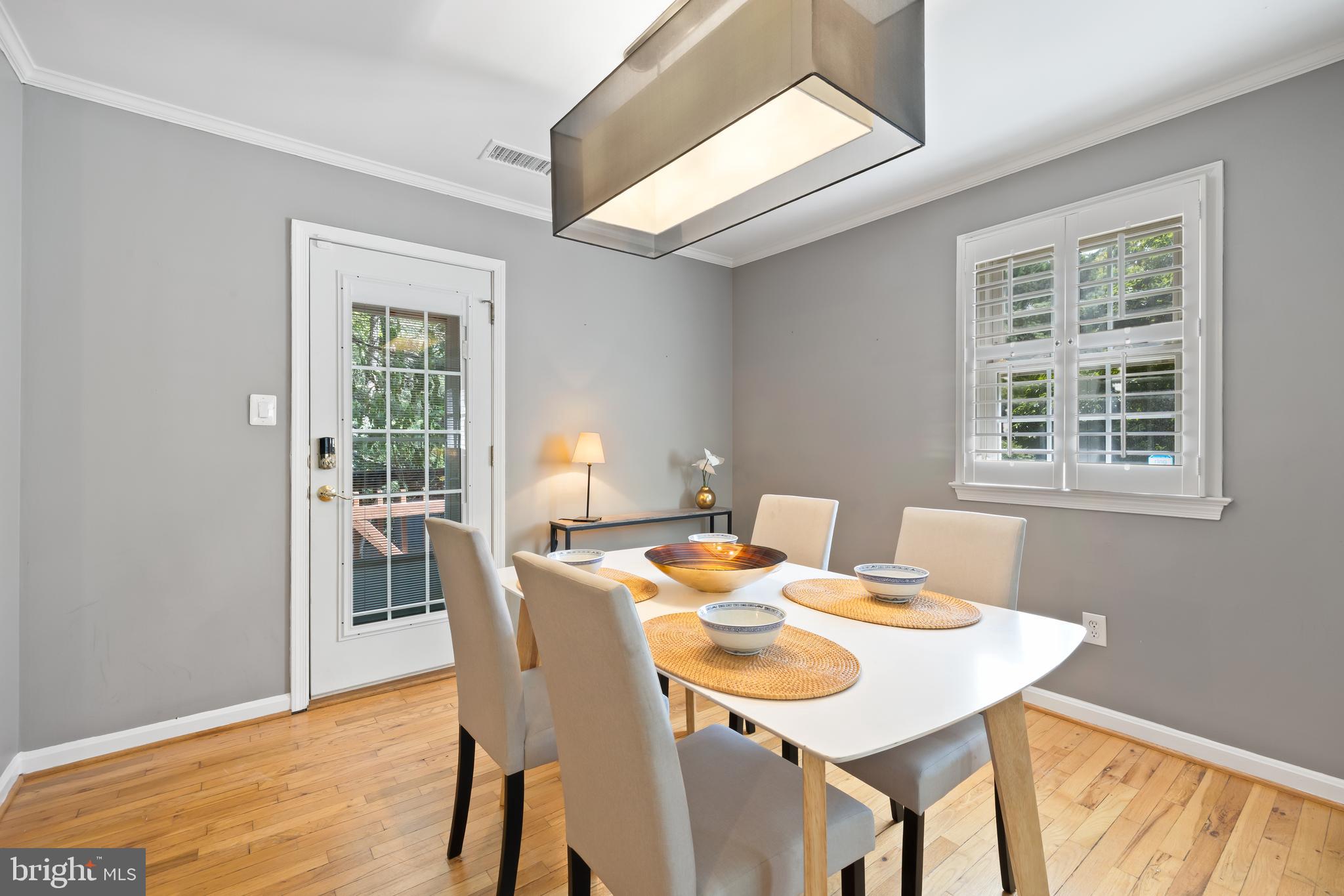 6721 Kenwood Forest Lane, Unit 45 Chevy Chase, MD 20815 - Photo 7 of 35 a view of a dining room with a table and chairs