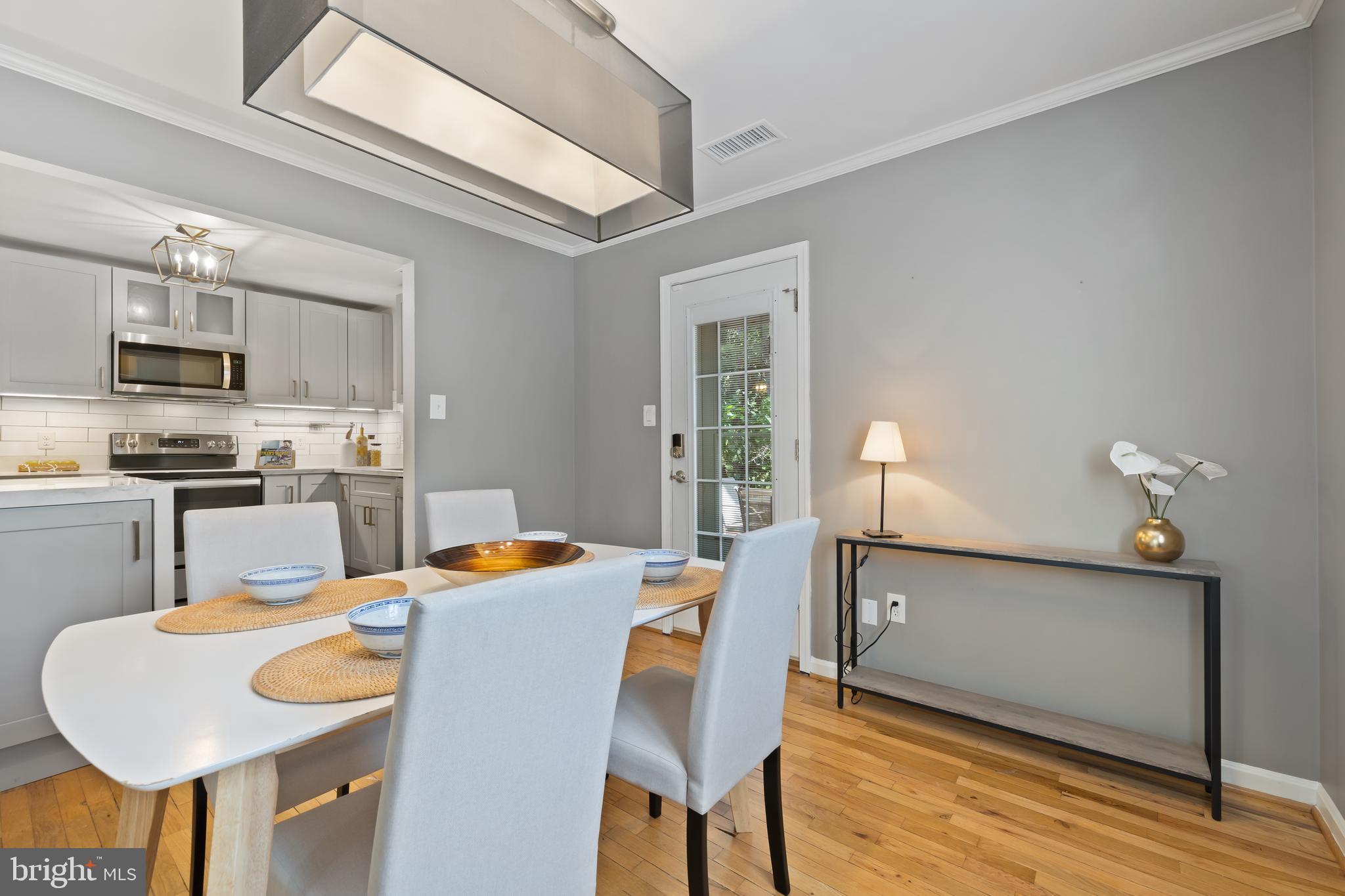 6721 Kenwood Forest Lane, Unit 45 Chevy Chase, MD 20815 - Photo 8 of 35 a view of a dining room with furniture and wooden floor