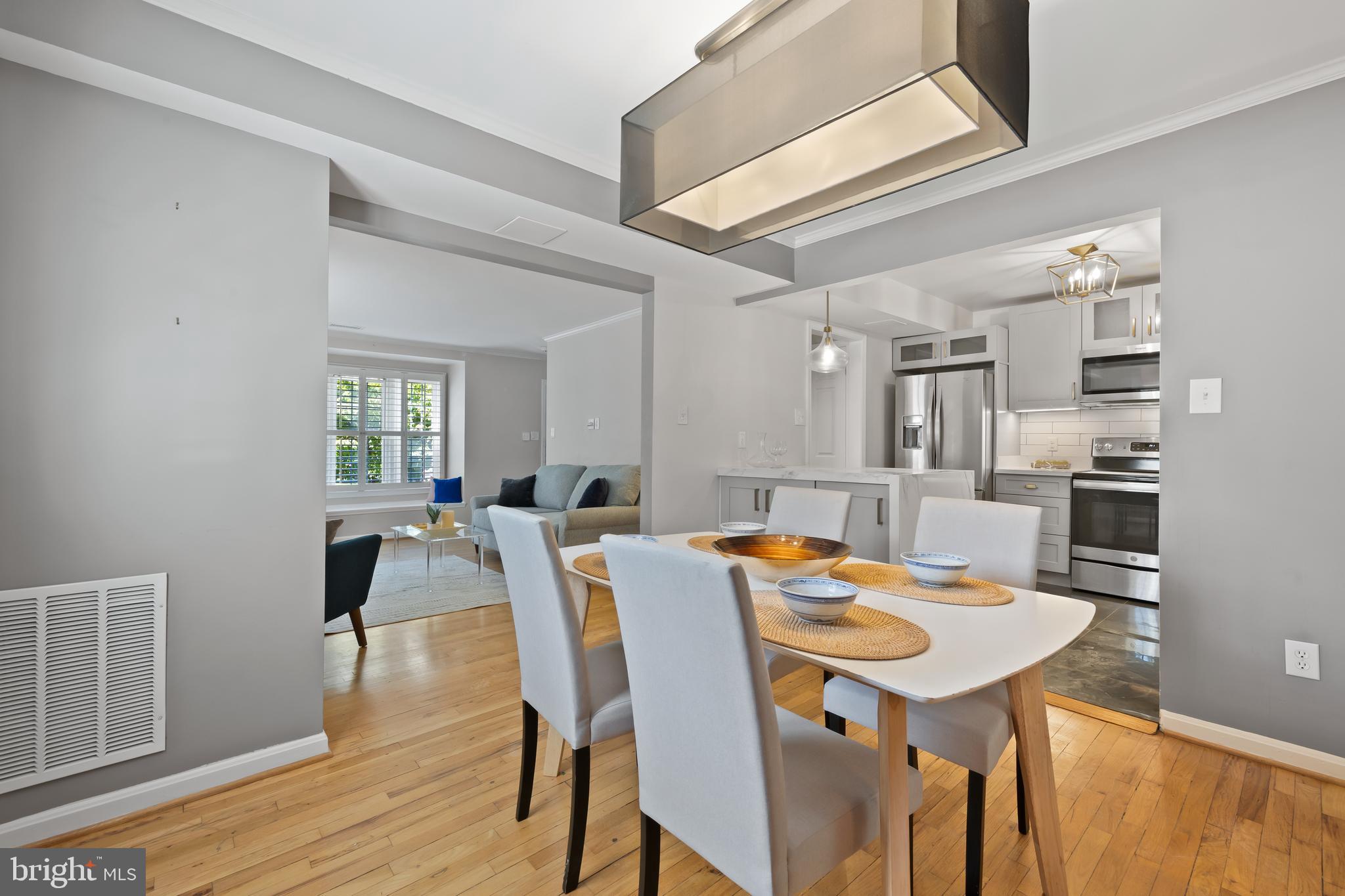 6721 Kenwood Forest Lane, Unit 45 Chevy Chase, MD 20815 - Photo 9 of 35 a view of a dining room with furniture and wooden floor