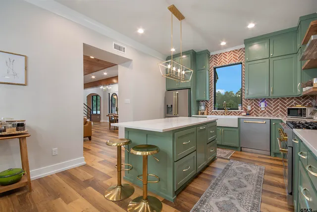 a kitchen with a sink stainless steel appliances and cabinets