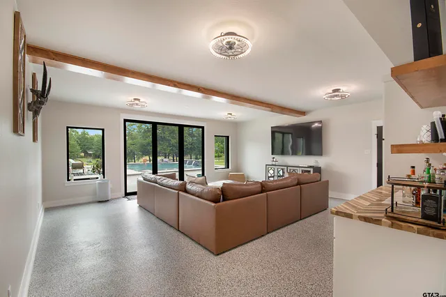 a spacious bedroom with a large bed and a window