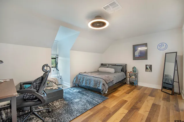 a view of a big house with a big yard and large trees