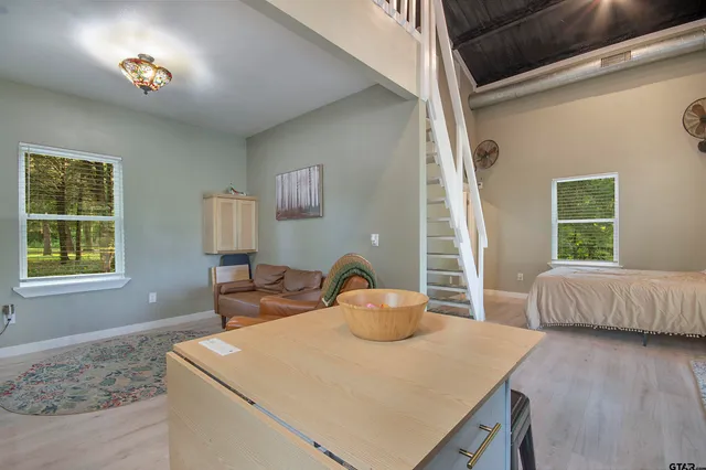 a bed sitting in a bedroom next to a window