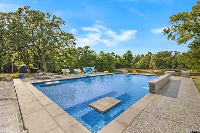 an aerial view of residential houses with outdoor space and lake view