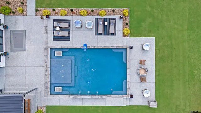 a living room with furniture a fireplace and a chandelier