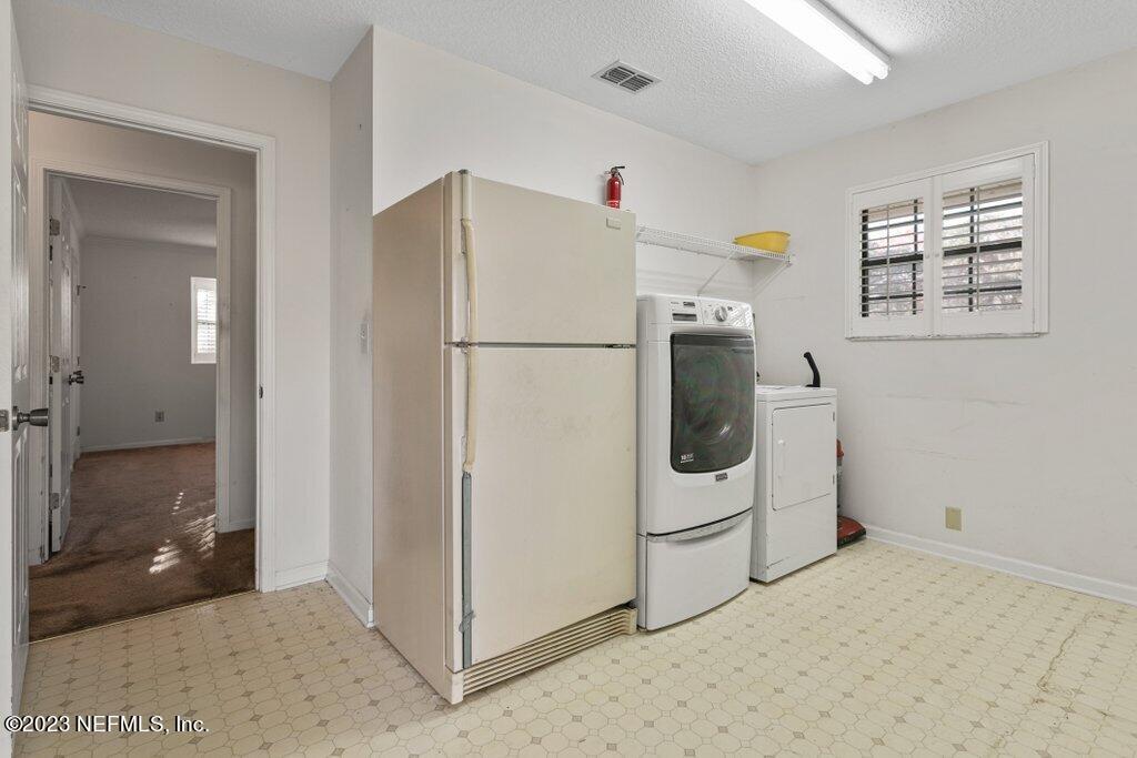 1271 Sheffield Road Jacksonville, FL 32259 - Photo 15 of 19 a white refrigerator freezer and a stove sitting inside of a kitchen