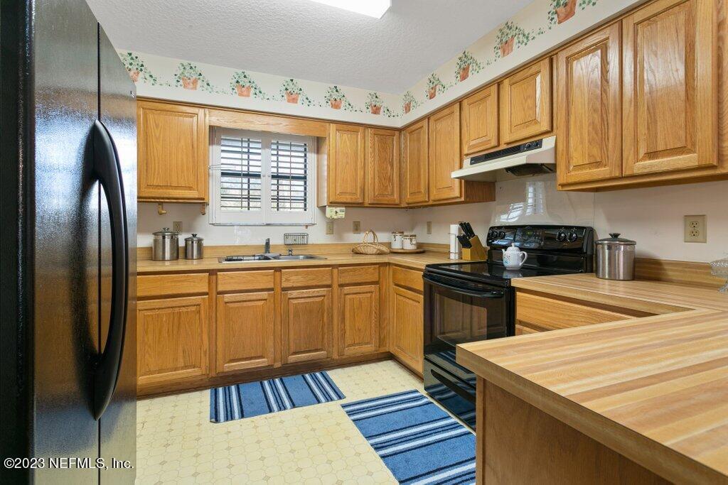 1271 Sheffield Road Jacksonville, FL 32259 - Photo 7 of 19 a kitchen with stainless steel appliances granite countertop a refrigerator a sink dishwasher a stove and white countertops with cabinets