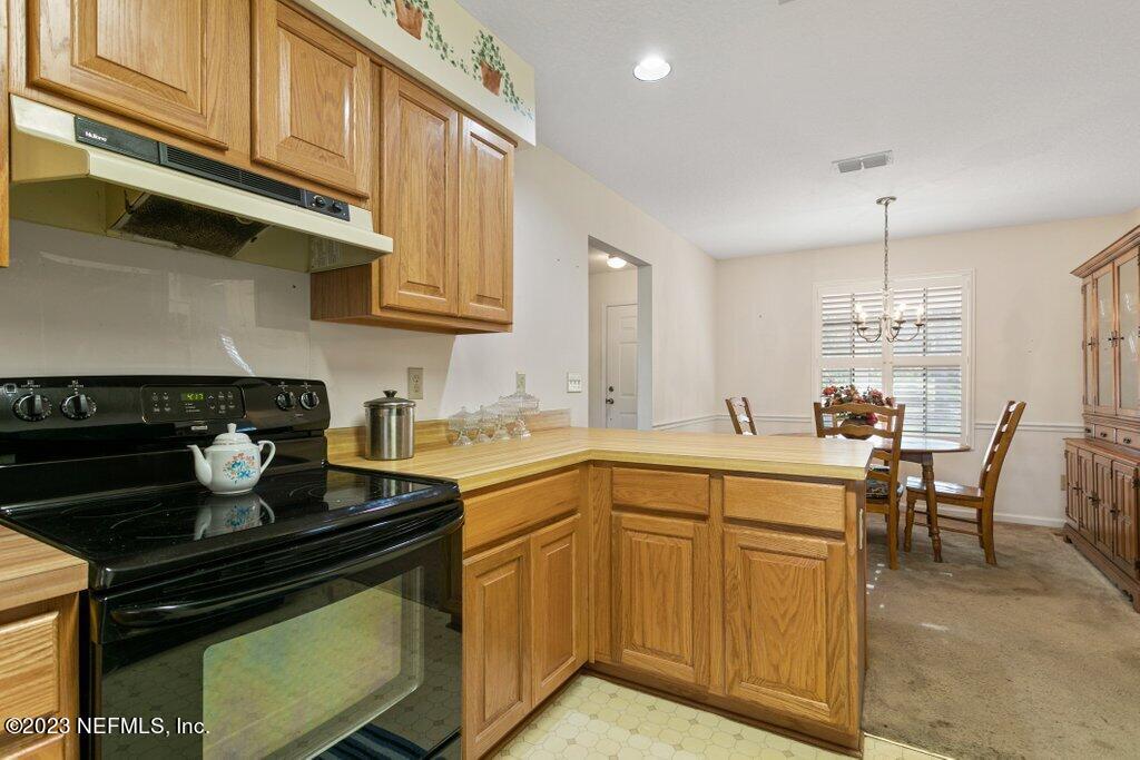 1271 Sheffield Road Jacksonville, FL 32259 - Photo 8 of 19 a kitchen with a stove and white cabinets
