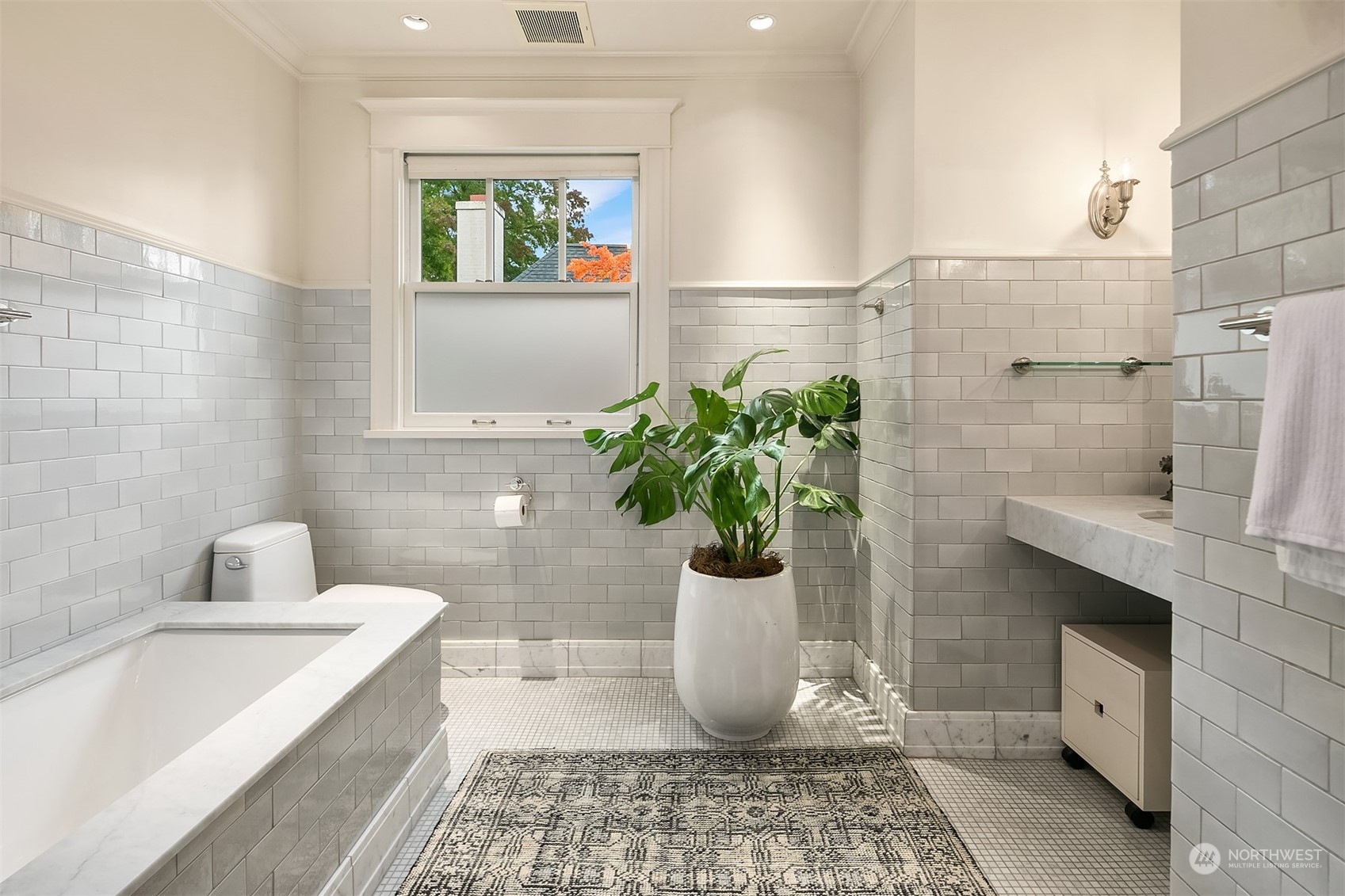 1121 22nd Avenue East Seattle, WA 98112 - Photo 20 of 40 a bathroom with a bathtub and a potted plant