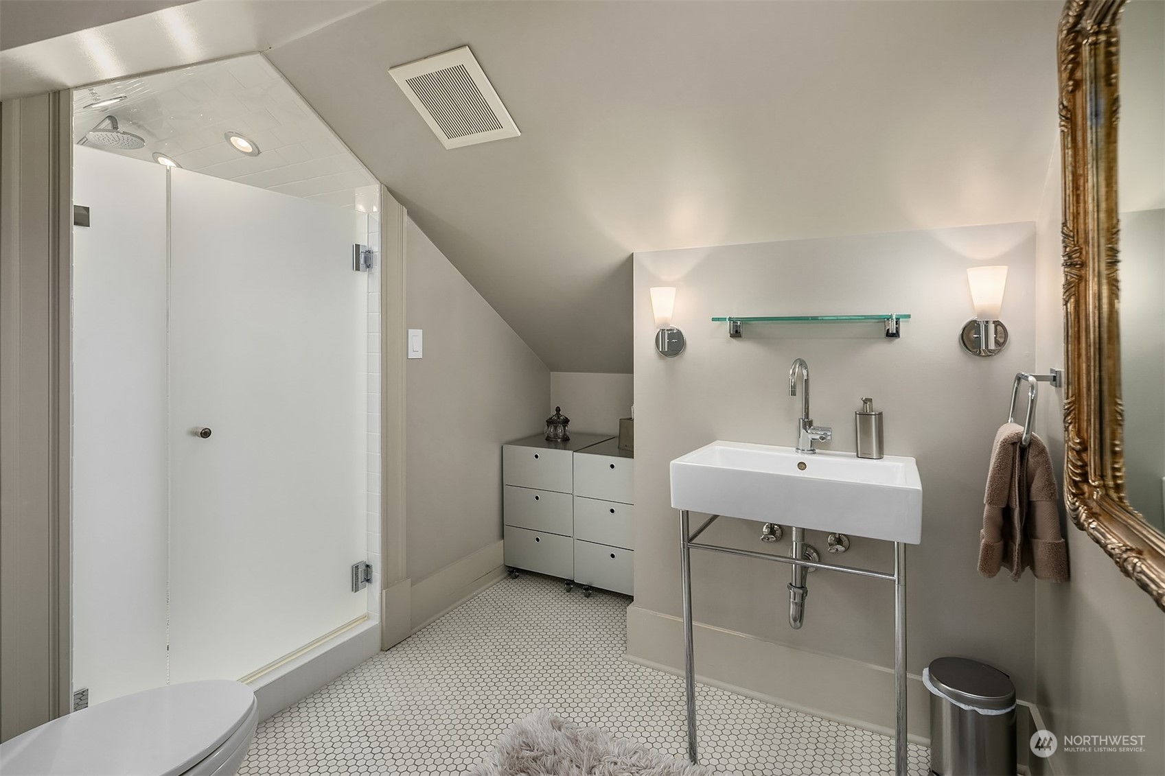 1121 22nd Avenue East Seattle, WA 98112 - Photo 26 of 40 a bathroom with a sink a toilet and mirror