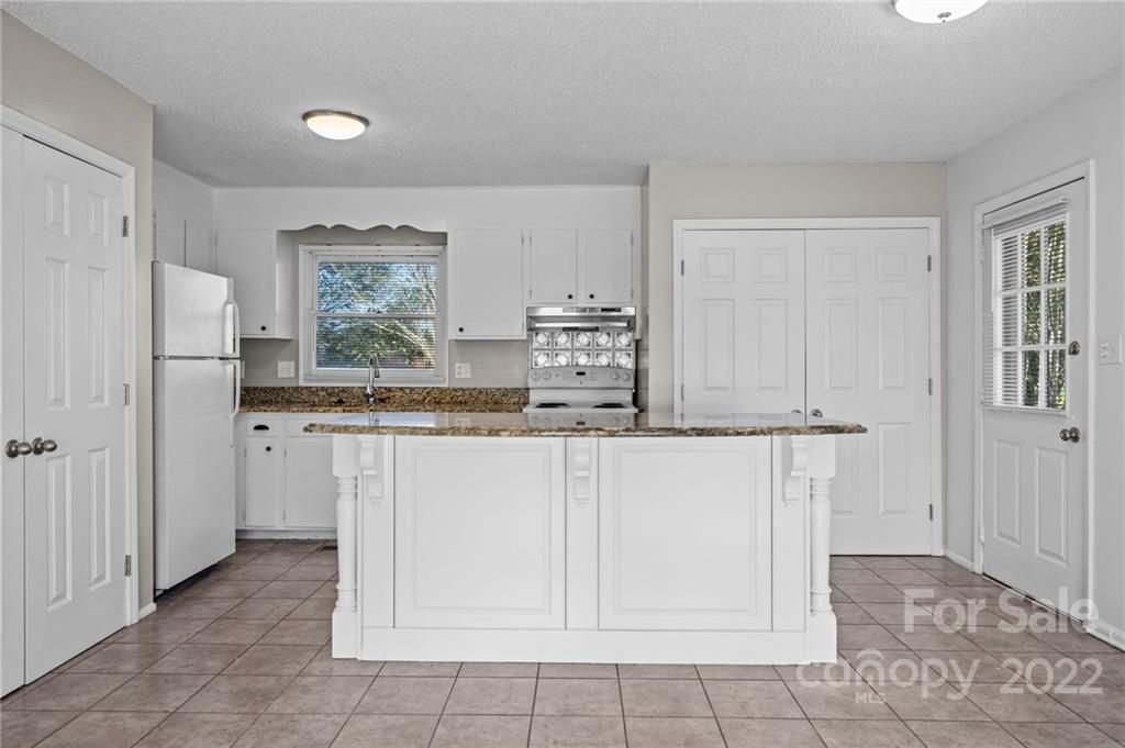 2328 Weddington Road Charlotte, NC 28270 - Photo 11 of 24 a kitchen with stainless steel appliances a sink and cabinets