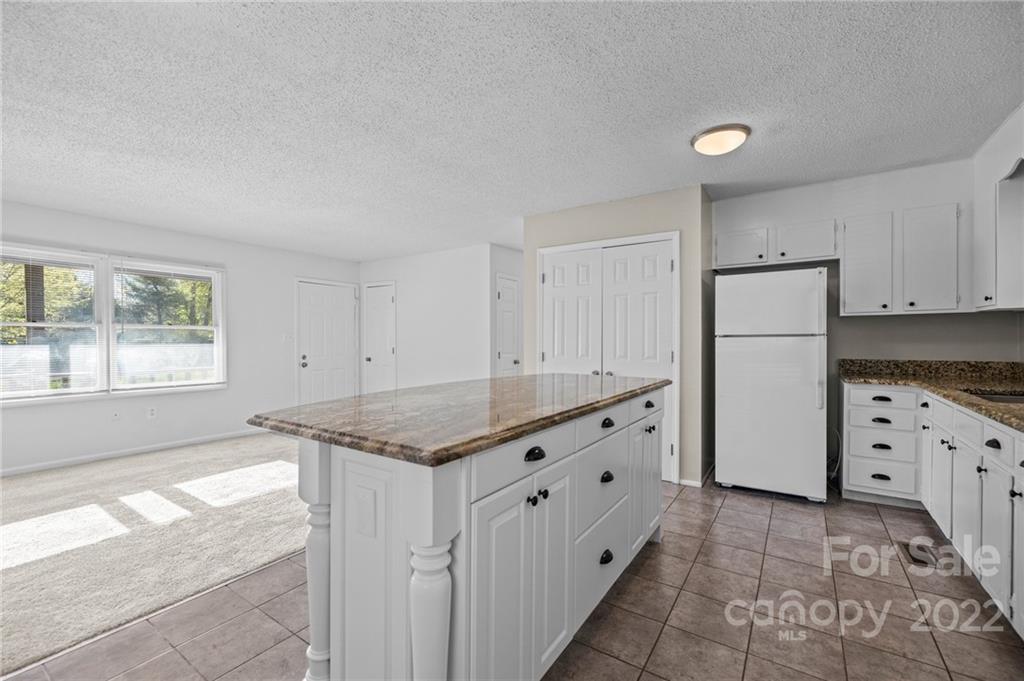 2328 Weddington Road Charlotte, NC 28270 - Photo 14 of 24 a kitchen with granite countertop a sink stove and refrigerator