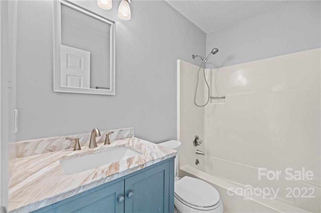 2328 Weddington Road Charlotte, NC 28270 - Photo 15 of 24 a bathroom with a granite countertop sink toilet and shower