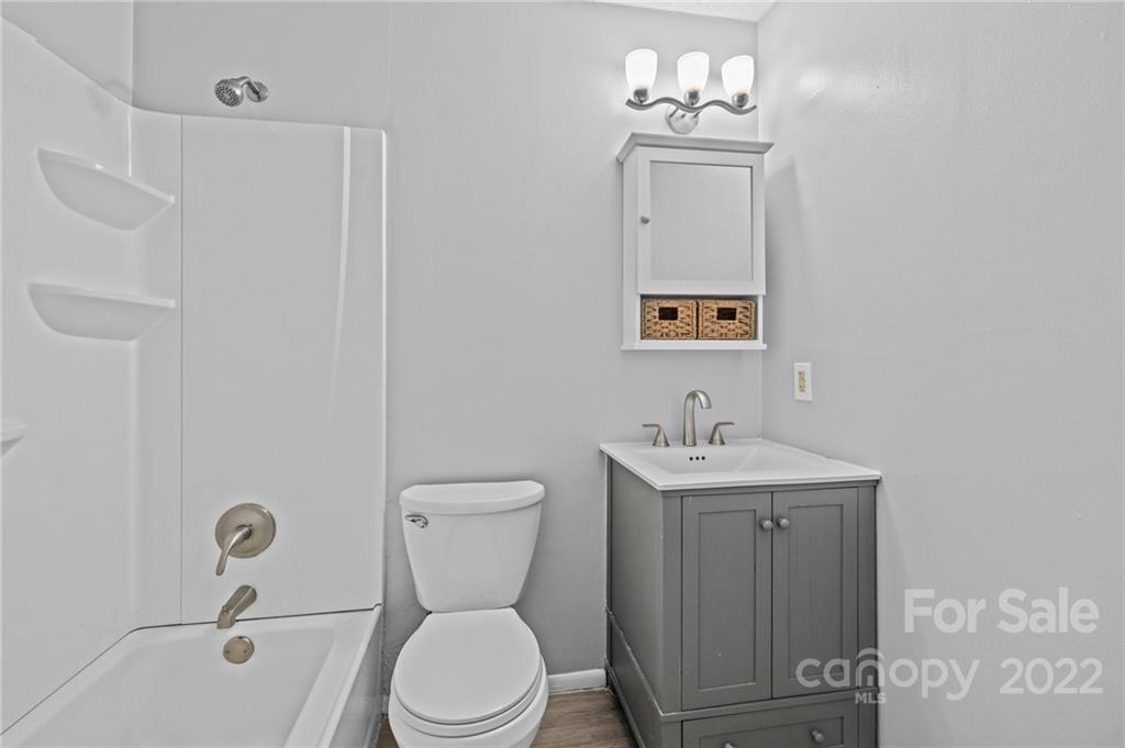 2328 Weddington Road Charlotte, NC 28270 - Photo 22 of 24 a bathroom with a toilet a sink and mirror