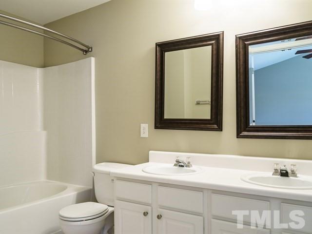 4213 Vienna Crest Drive Raleigh, NC 27613 - Photo 18 of 24 a bathroom with a sink and a mirror