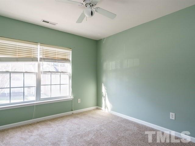 4213 Vienna Crest Drive Raleigh, NC 27613 - Photo 20 of 24 an empty room with a window and ceiling fan