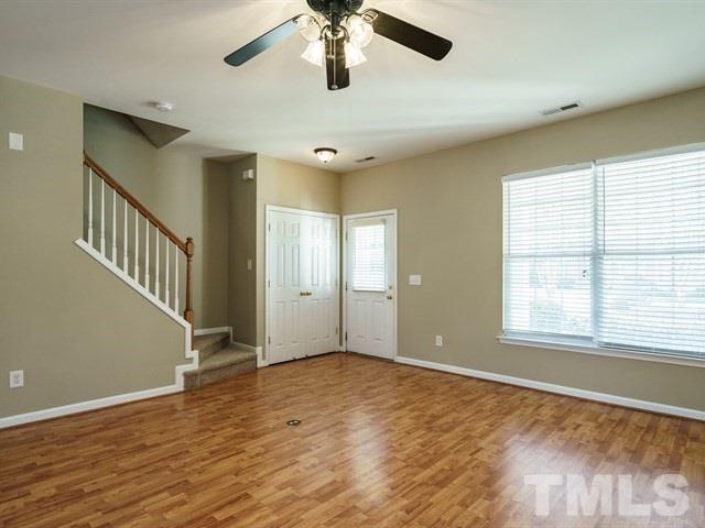4213 Vienna Crest Drive Raleigh, NC 27613 - Photo 3 of 24 a view of an empty room with wooden floor and a window