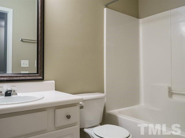 4213 Vienna Crest Drive Raleigh, NC 27613 - Photo 21 of 24 a bathroom with a sink and a toilet