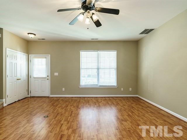 4213 Vienna Crest Drive Raleigh, NC 27613 - Photo 4 of 24 wooden floor in an empty room with a window