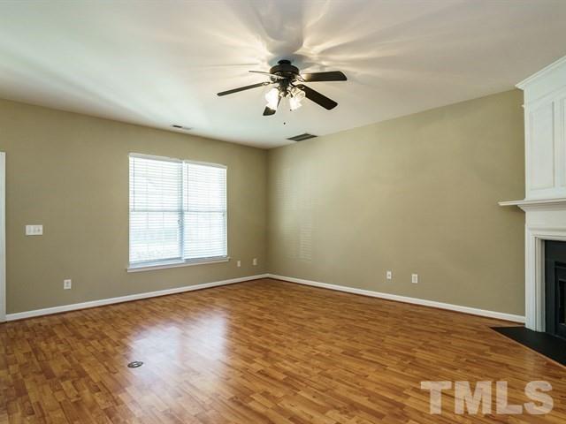 4213 Vienna Crest Drive Raleigh, NC 27613 - Photo 5 of 24 wooden floor in an empty room with a window