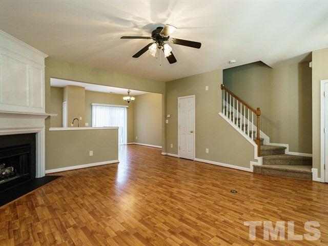 4213 Vienna Crest Drive Raleigh, NC 27613 - Photo 8 of 24 a view of an empty room with wooden floor fireplace and a window