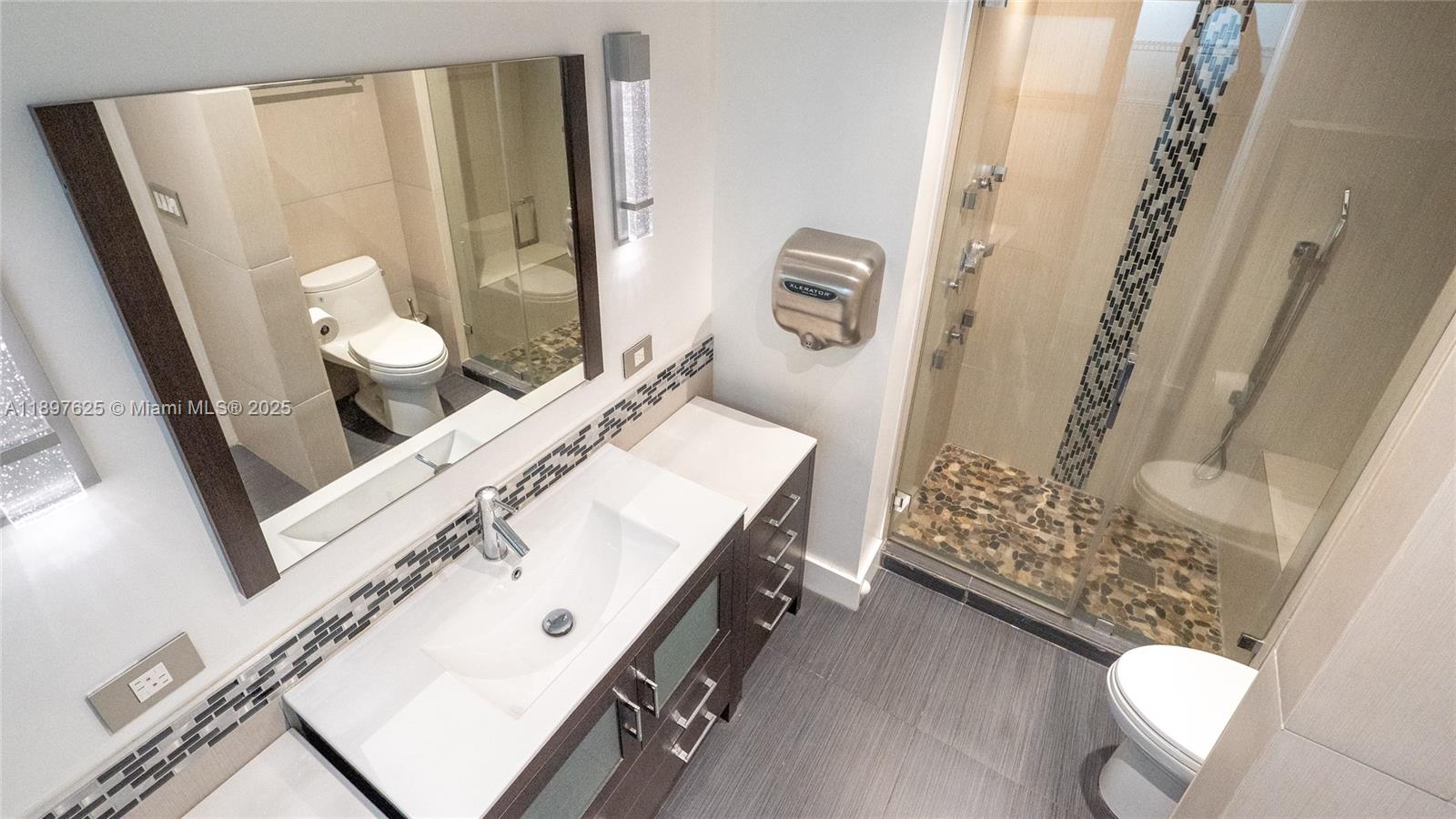 11851 Northwest 7th Street Plantation, FL 33325 - Photo 23 of 72 a bathroom with a sink mirror vanity and toilet