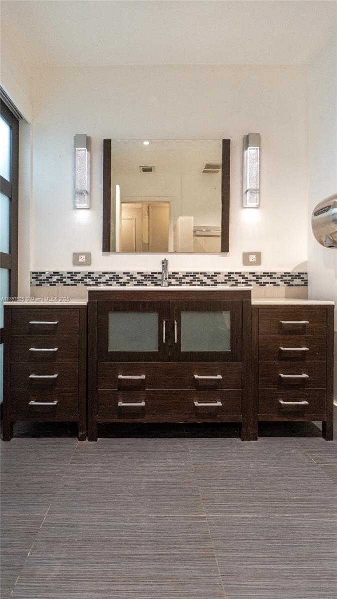 11851 Northwest 7th Street Plantation, FL 33325 - Photo 24 of 72 a bathroom with a granite countertop sink and a mirror
