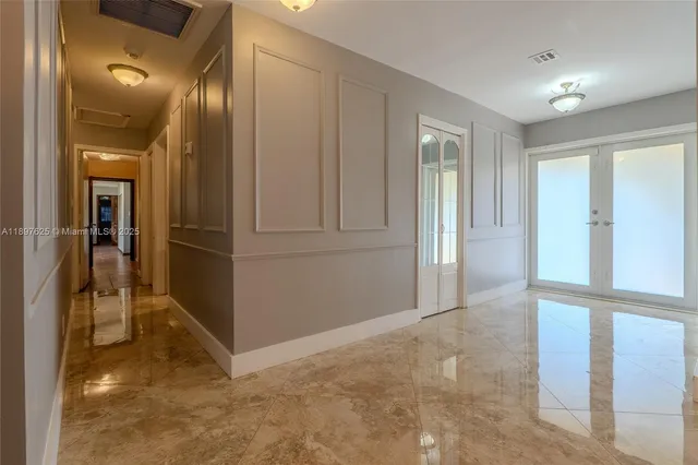 a view of a dining room with furniture chandelier and a floor to ceiling window