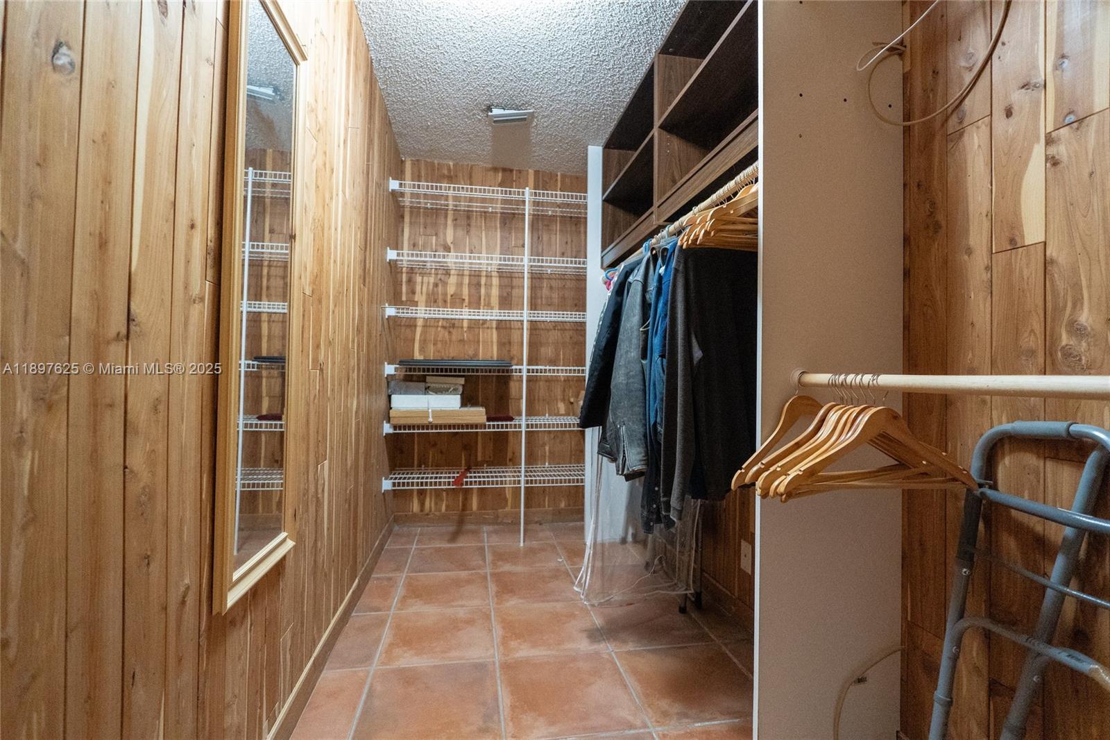 11851 Northwest 7th Street Plantation, FL 33325 - Photo 44 of 72 a view of walk in closet with clothes and shoes