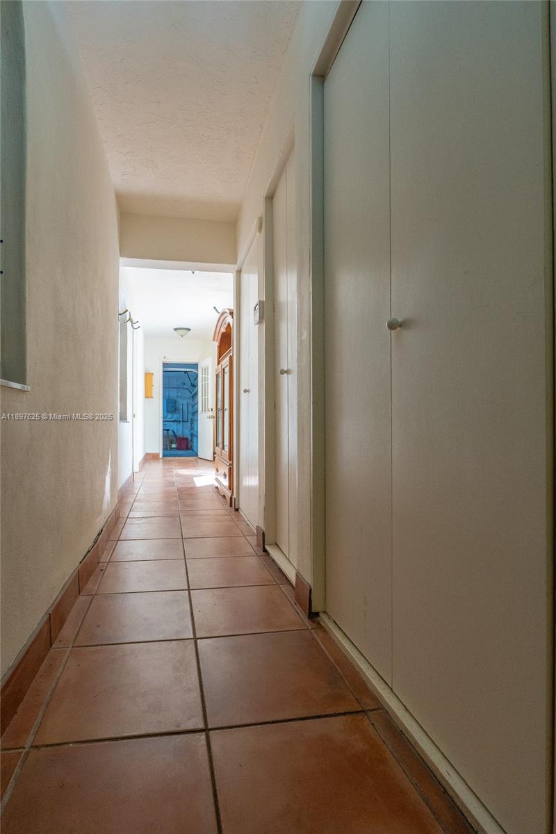 11851 Northwest 7th Street Plantation, FL 33325 - Photo 45 of 72 a hallway with sliding door and yard in back