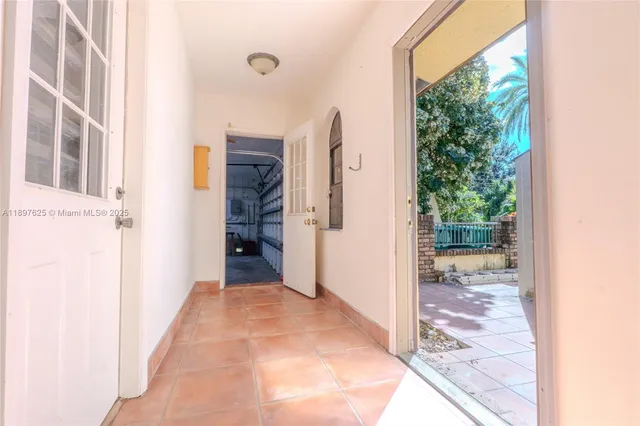 a view of backyard with large trees and plants