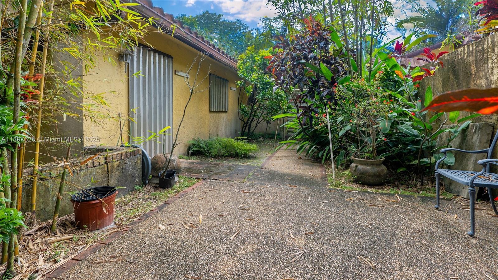 11851 Northwest 7th Street Plantation, FL 33325 - Photo 54 of 72 a view of a backyard with plants and a patio