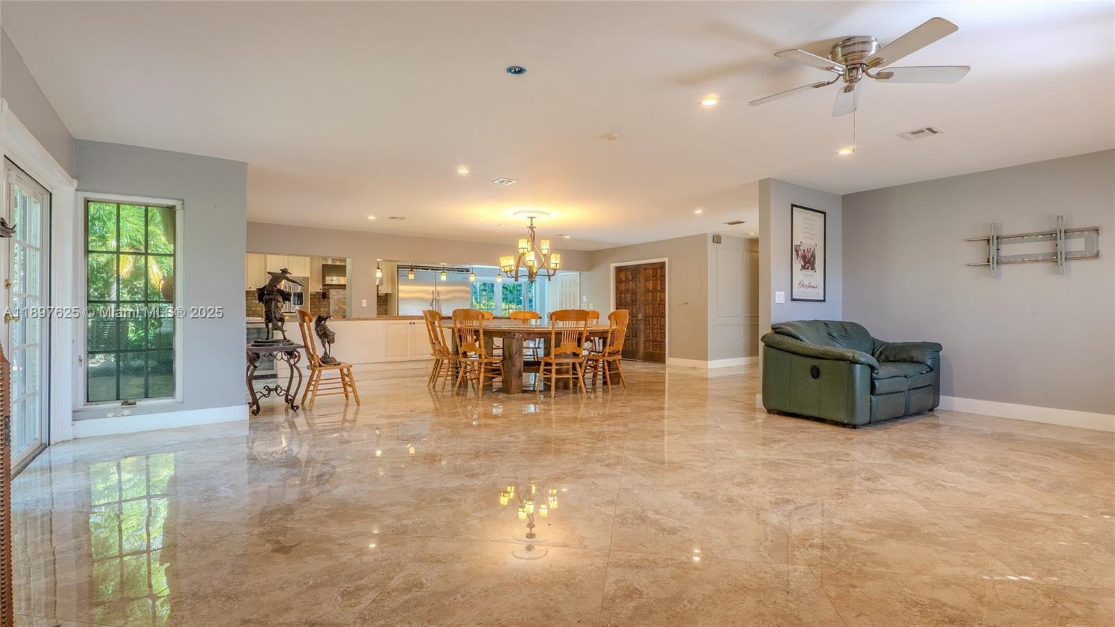 11851 Northwest 7th Street Plantation, FL 33325 - Photo 7 of 72 a view of a dining room with furniture chandelier and a floor to ceiling window