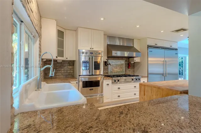 a kitchen with wooden cabinets and a stove top oven