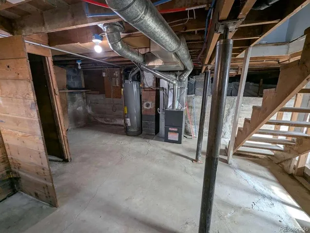 a view of water heater room with wooden floor