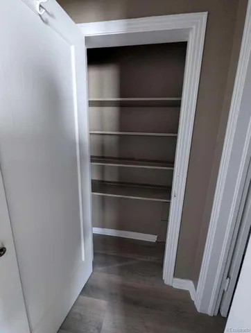a view of walk in closet with empty racks