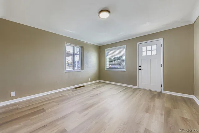 an empty room with windows and closet