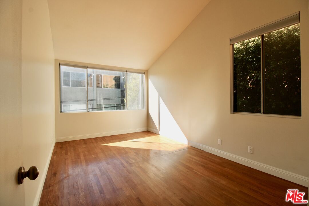 1825 Thayer Avenue Los Angeles, CA 90025 - Photo 17 of 38 a view of an empty room with wooden floor and a window