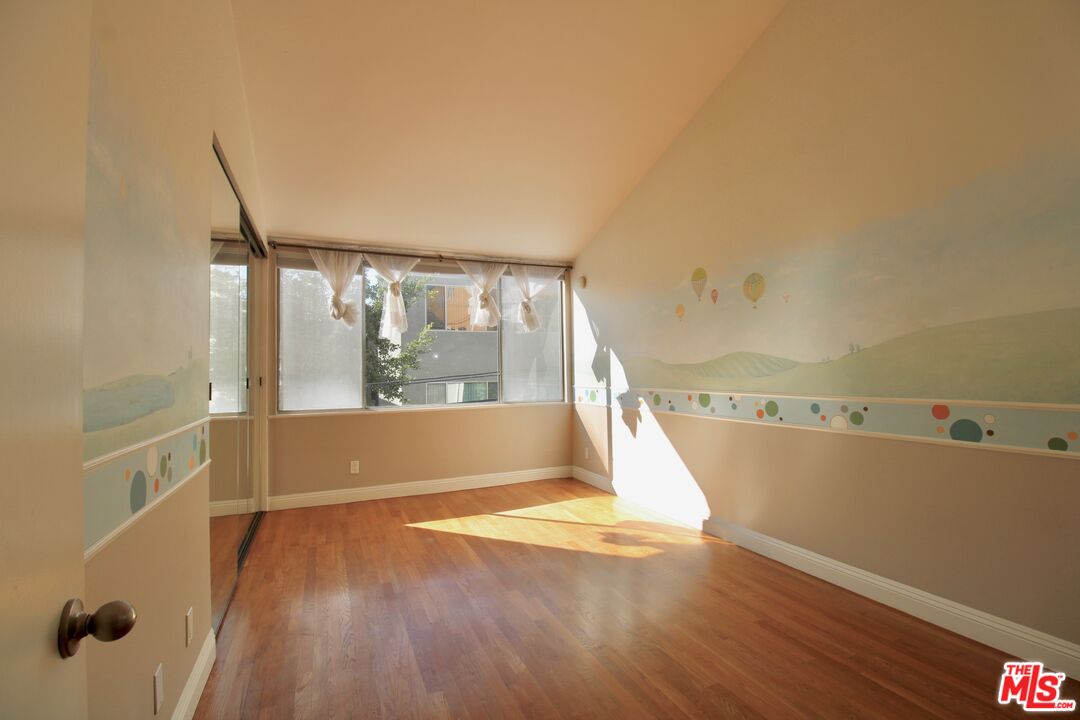 1825 Thayer Avenue Los Angeles, CA 90025 - Photo 22 of 38 a view of a room with wooden floor and a window