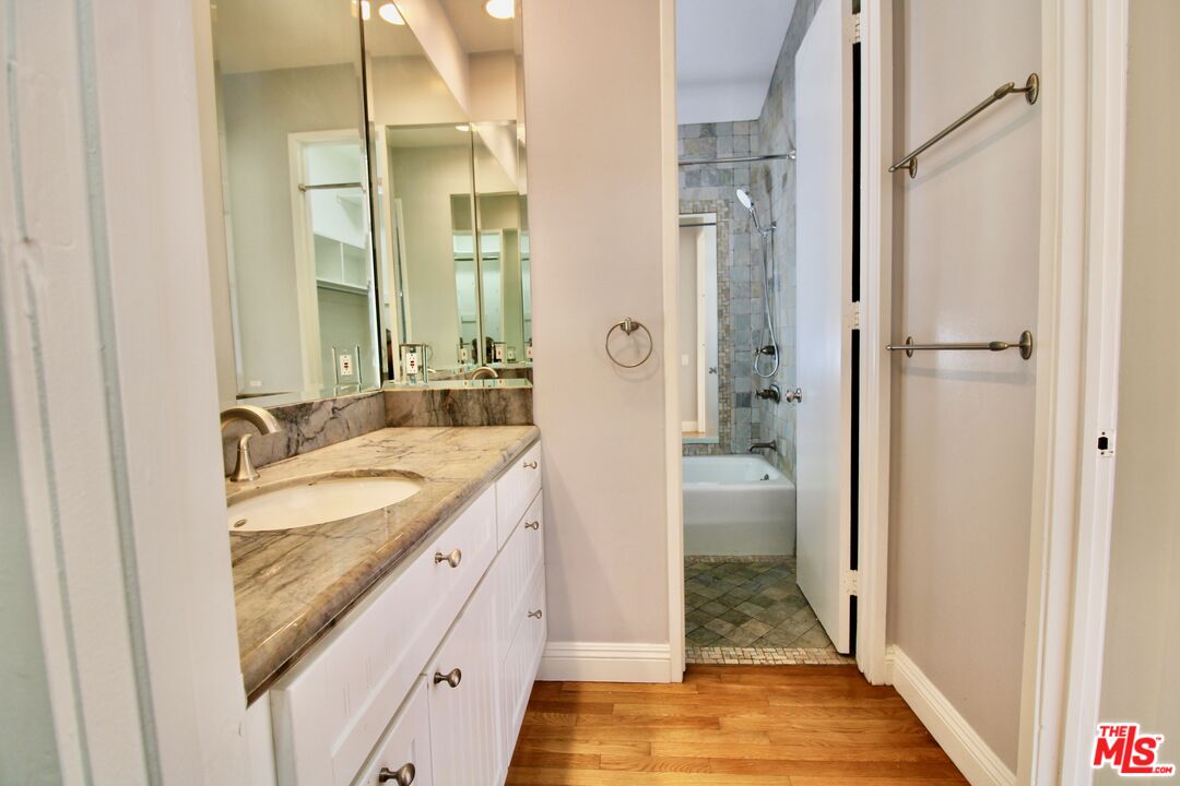 1825 Thayer Avenue Los Angeles, CA 90025 - Photo 26 of 38 a bathroom with a granite countertop sink and a mirror