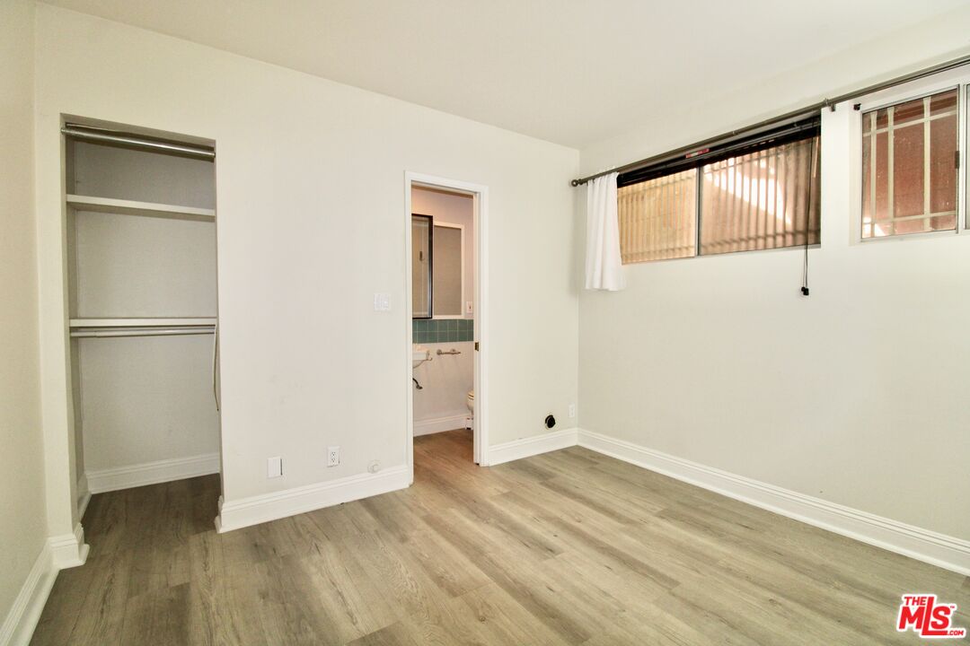 1825 Thayer Avenue Los Angeles, CA 90025 - Photo 33 of 38 a view of an empty room with wooden floor and a window