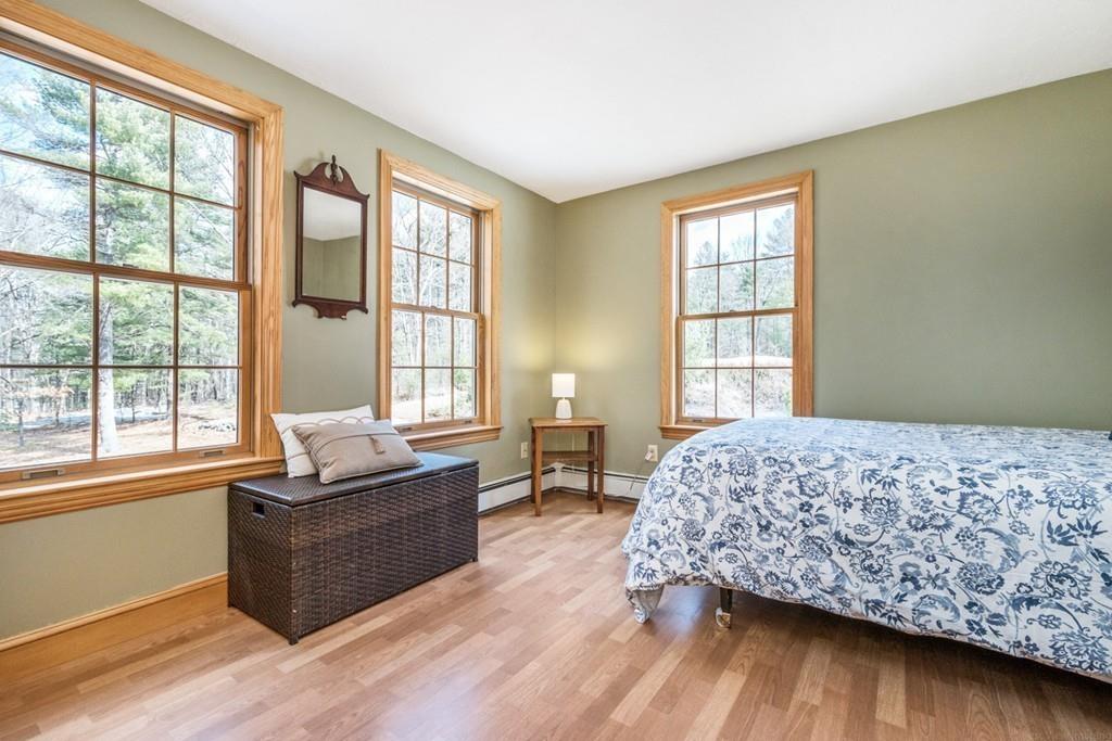 16 South Shaker Road Harvard, MA 01451 - Photo 18 of 31 a bedroom with a bed and wooden floor
