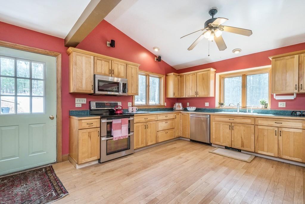 16 South Shaker Road Harvard, MA 01451 - Photo 5 of 31 a kitchen with stainless steel appliances kitchen island granite countertop a stove a sink and a microwave