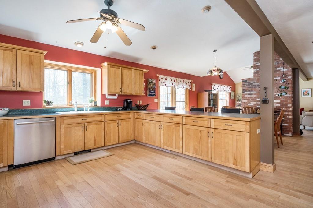 16 South Shaker Road Harvard, MA 01451 - Photo 6 of 31 a kitchen with stainless steel appliances sink cabinets and wooden floor