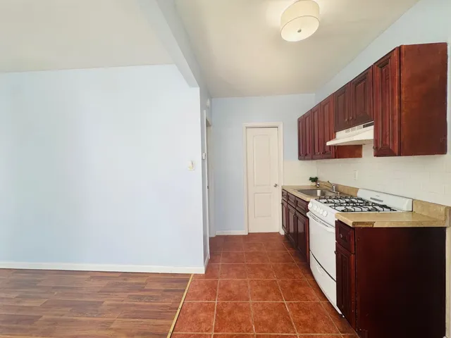 a kitchen with a cabinets and a stove top oven