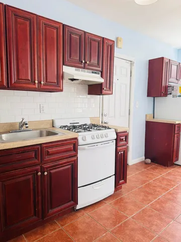 a kitchen with stainless steel appliances granite countertop a sink stove and cabinets