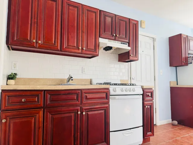 a kitchen with stainless steel appliances granite countertop a refrigerator and cabinets