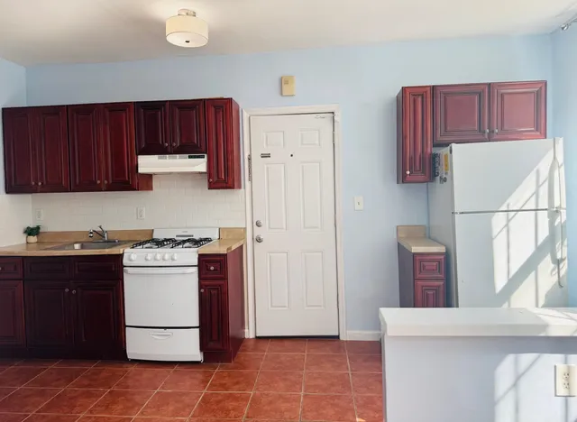 a kitchen with stainless steel appliances granite countertop a refrigerator stove a sink and dishwasher