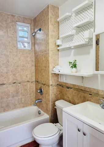 a bathroom with a sink a toilet and bathtub