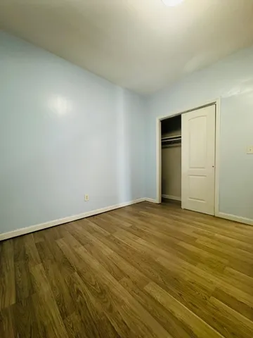 a view of an empty room and wooden floor